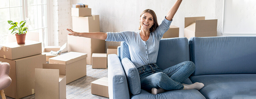 Happy Women Sitting On Couch After Moving Abroad
