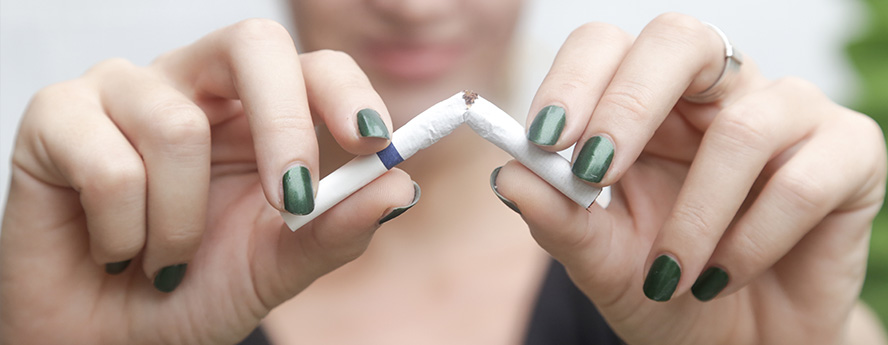 Women breaking cigarette to quit smoking