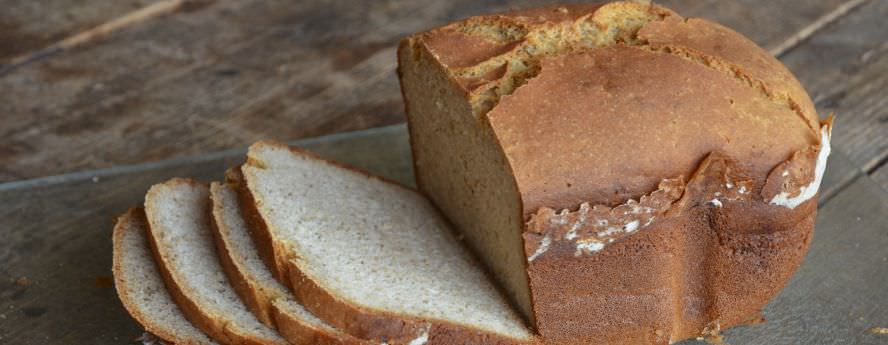 Gluten Free Loaf Of Bread And Slices On Table