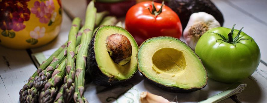 Fresh Vegetables On Counter Avocado Tomato Asparagus Garlic For Vegetarian And Vegan Food Diet