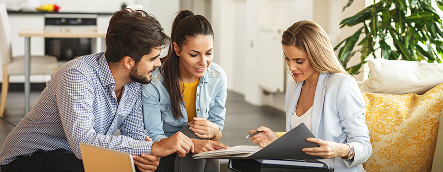 Women showing couple what health insurance excess is