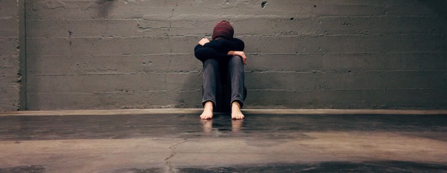 Person Sitting On Cold Floor Crying Feeling Lonely And Isolated With Anxiety