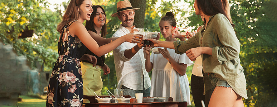 Group Of Young Friends Drinking And Eating Outside