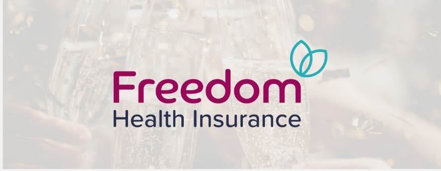 Freedom Health Insurance logo displayed over a blurred celebratory background with champagne glasses.