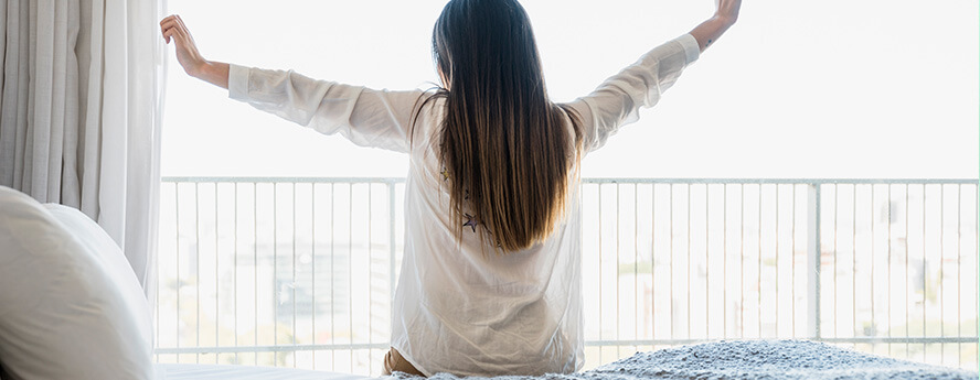 Woman Waking Up In Morning Sunlight